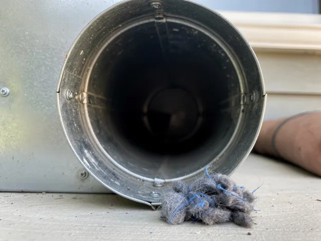 Pico Rivera Dryer Vent Cleaning technician using specialized equipment to clear severe dryer vent blockage in Pico Rivera